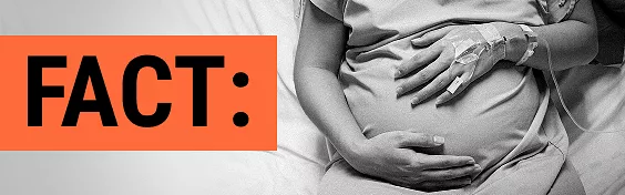Pregnant patient cradling her stomach in a hospital bed with a text callout of the word FACT